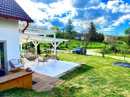 a patio with a table and chairs in a yard at Bohemian Lodge in Kisapáti