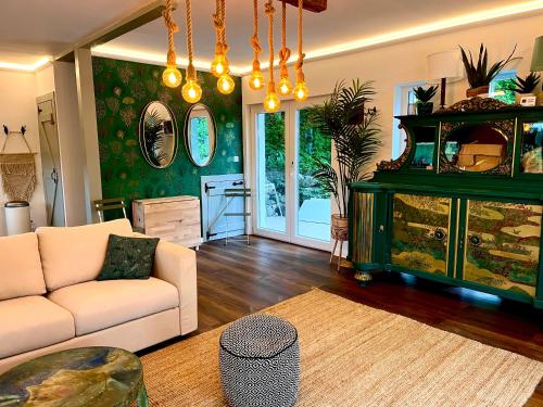 a living room with a couch and a table at Bohemian Lodge in Kisapáti