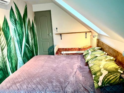a bedroom with a bed with a purple comforter at Bohemian Lodge in Kisapáti