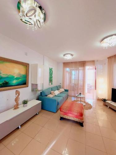 a living room with a blue couch and a table at House with a tropical garden in Adeje