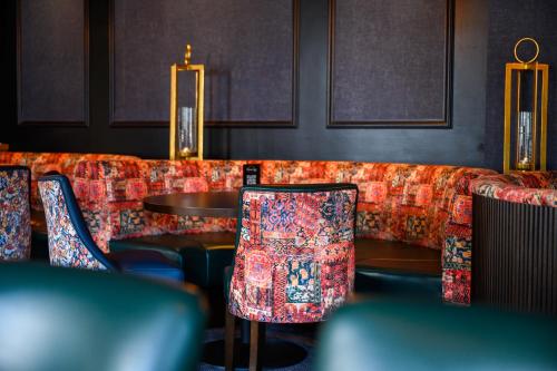 a restaurant with a couch with chairs and a table at Newtown Park Hotel in Wexford
