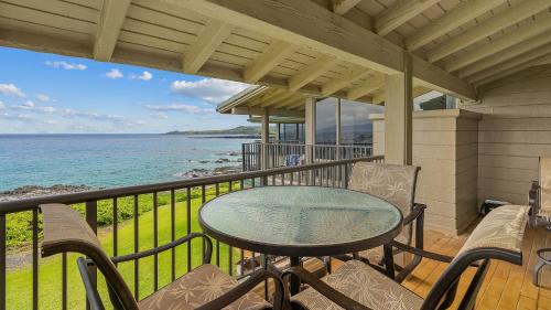a balcony with a table and chairs and the ocean at Kapalua Bay Villa 30B1 in Kapalua