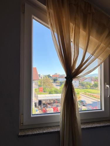 a window with a curtain in front of it at Sobe i Apartman R Bileća in Bileća
