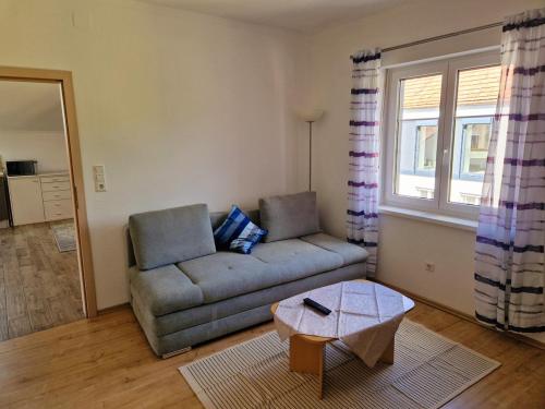 a living room with a couch and a table at Apartment Schlossblick in Loosdorf