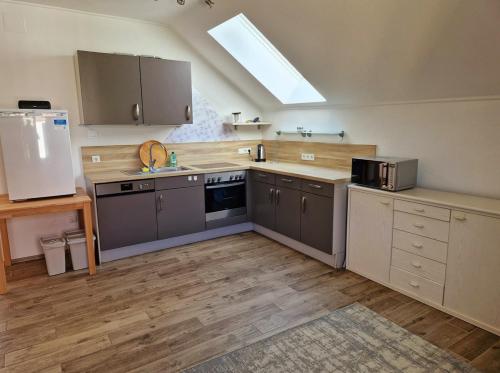 a kitchen with a sink and a refrigerator at Apartment Schlossblick in Loosdorf