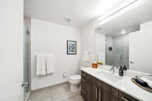 a white bathroom with a sink and a toilet at Sentral Michigan Avenue in Chicago