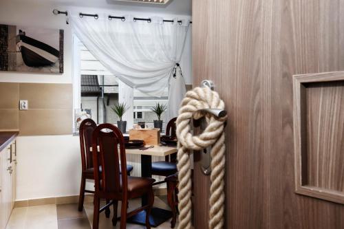 a kitchen and dining room with a table and chairs at Sejf House in Gdańsk