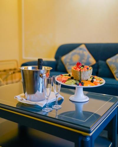 a table with a plate of cake and wine glasses at Altafiumara Resort & Spa in Villa San Giovanni
