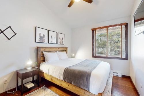 a bedroom with a large bed and a window at Snowmass Village 95 in Snowmass Village