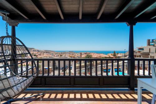 a view from a balcony with a hammock at Villa Magnificent 5-star with sea view, jacuzzi and pool in Arguineguín
