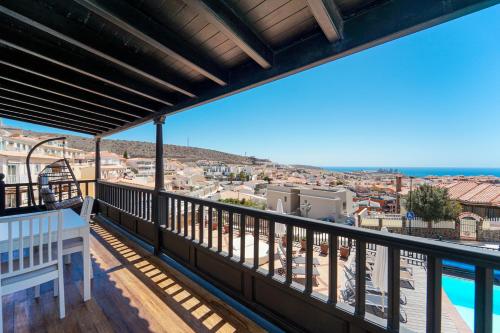 a balcony with a view of a city at Villa Magnificent 5-star with sea view, jacuzzi and pool in Arguineguín