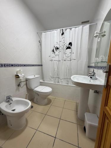 a bathroom with a toilet and a sink at Nuevo Hostal Rasil in Nohales