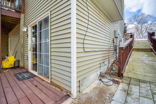 a side of a house with a wooden porch at Charming Basement Stay with Workspace AC & Fire Pit in North Saint Paul