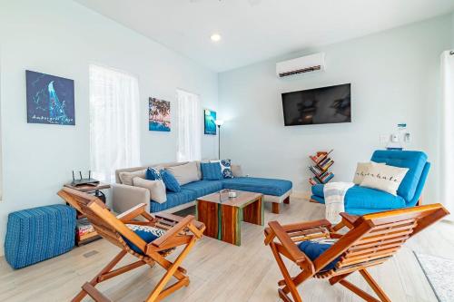 a living room with two chairs and a blue couch at 4 Br Belize Beachfront Villa W Pool, Beach & Pier in Basil Jones