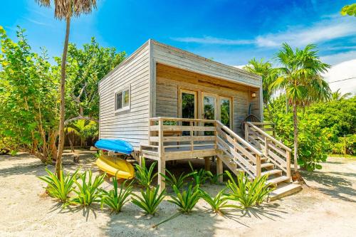 a tiny house with a porch and a deck at 4 Br Belize Beachfront Villa W Pool, Beach & Pier in Basil Jones