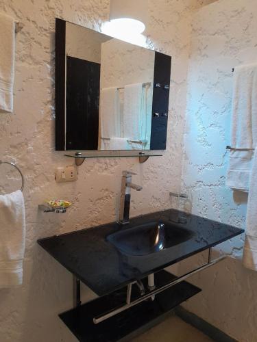 a bathroom with a sink and a mirror at StevieWonderLand Playa El Yaque in El Yaque