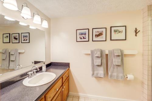 a bathroom with a sink and a mirror at Walk to Ski Slopes Sugar Mountain Unit with Balcony in Sugar Mountain