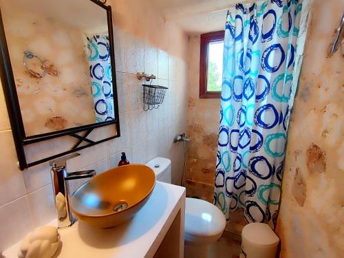 a bathroom with a sink and a toilet and a shower at Spasmata Village Special Maizonette only adults in Minia