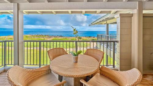 a table and chairs on a balcony with a view of the ocean at Kapalua Bay Villa 35B2 in Kapalua