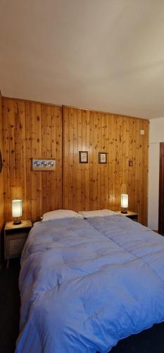Una cama o camas en una habitación de Rifugio dei Pini