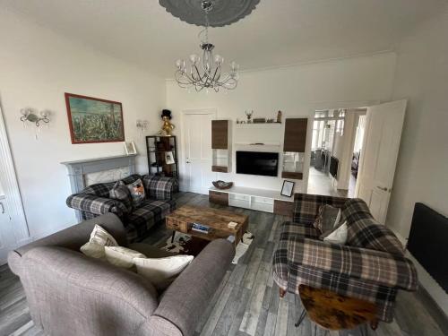 a living room with two couches and a coffee table at Isle of Bute Blissful Retreat- Stunning 3 Bed Flat in Rothesay