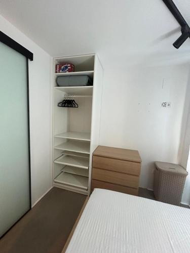 a bedroom with a bed and a closet at Apto 2.Duplex con jardin.Centrico- in Villanueva de la Cañada