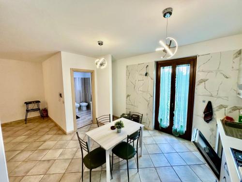 a kitchen and dining room with a table and chairs at Villa Tuscia apartments in Tuscania