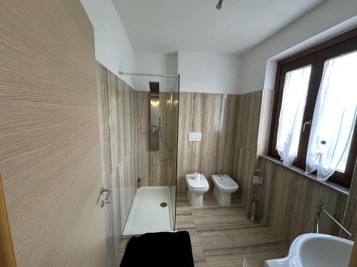 a bathroom with a sink and a toilet and a window at Villa Tuscia apartments in Tuscania