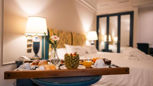 a tray of food on a table in a hotel room at Altafiumara Resort & Spa in Villa San Giovanni