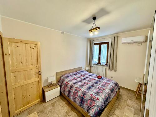 a bedroom with a bed and a window and a door at Villa Tuscia apartments in Tuscania