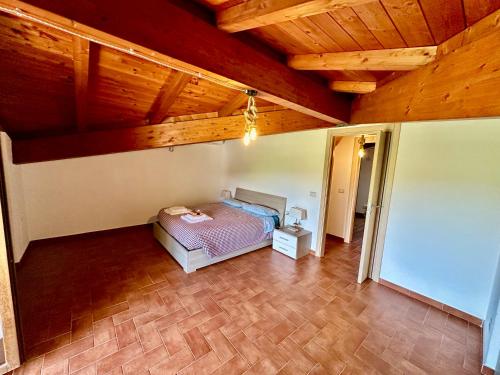 a bedroom with a bed in a room with wooden ceilings at Villa Tuscia apartments in Tuscania