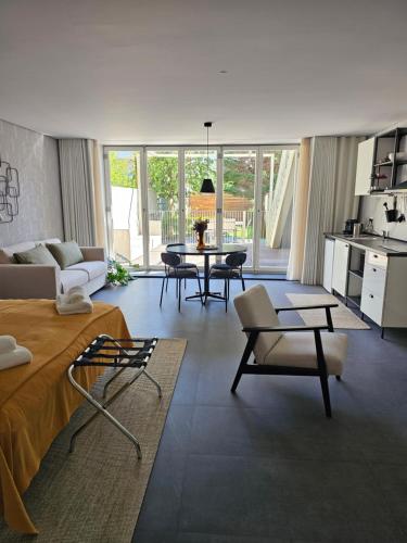 a living room with a couch and a table with chairs at Lima Junior Residences in Porto
