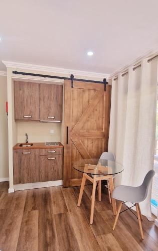 a kitchen with a table and a sliding barn door at Cerca Velha Alentejo House in Cercal