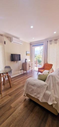 a bedroom with a bed and a desk and a television at Cerca Velha Alentejo House in Cercal