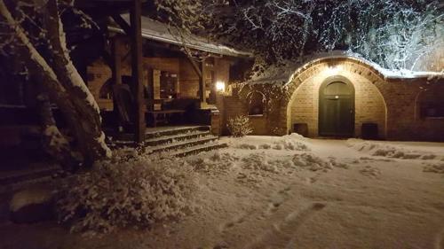 a building with a door in the snow at night at House Mikin Dol in Draž