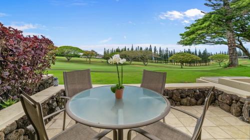 a table with a vase with a flower on it at Kapalua Golf Villa 15P78 in Kapalua