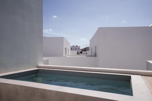 a swimming pool on the balcony of a house at Poema Antiparos in Antiparos