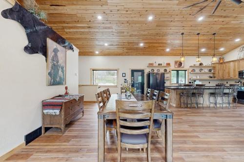a dining room and kitchen with a wooden ceiling at Bear Butte Hideaway in Deadwood