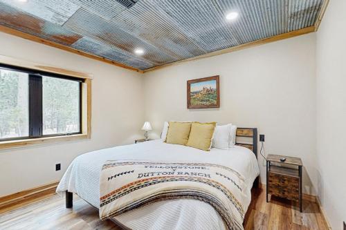 a bedroom with a bed and a window at Bear Butte Hideaway in Deadwood