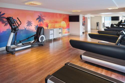 a gym with treadmills and exercise equipment in a room at Holiday Inn Express Waikiki by IHG in Honolulu