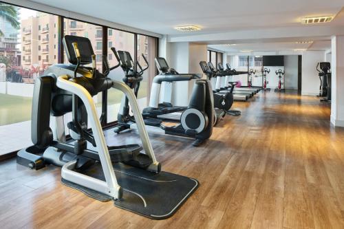 a gym with several treadmills and elliptical machines at Holiday Inn Express Waikiki by IHG in Honolulu