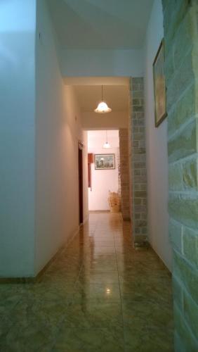 a hallway with a brick wall and a white door at Apart Ma & Cris in Termas de Río Hondo