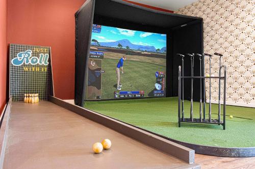 a bowling alley with a video game on the screen at The Albatross Estate & Golf Links in Fletcher