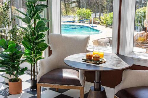 a table with two glasses of orange juice on a porch at The Albatross Estate & Golf Links in Fletcher