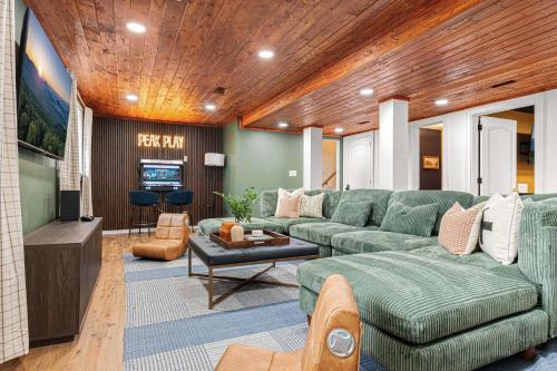 a living room with a green couch and a television at The Albatross Estate & Golf Links in Fletcher