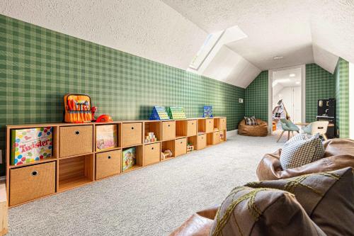a childs room with green tiled walls and wooden shelves at The Albatross Estate & Golf Links in Fletcher