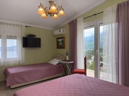a bedroom with two beds and a window at VILA TARA in Sutomore