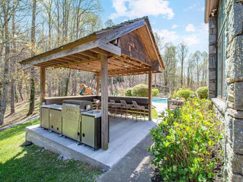 a pavilion with a table and chairs on a patio at The Albatross Estate & Golf Links in Fletcher