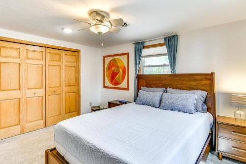 a bedroom with a bed and a ceiling fan at Breathtaking Sunsets Lake Huron Beachfront Escape in Alpena