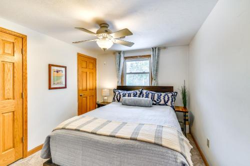 a bedroom with a bed with a ceiling fan at Breathtaking Sunsets Lake Huron Beachfront Escape in Alpena